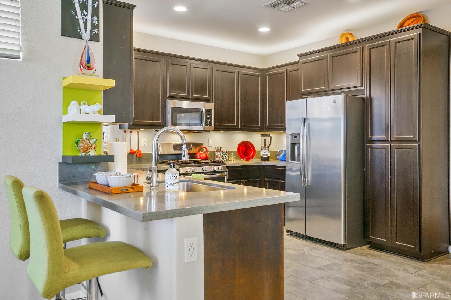 190 Belle Harbor Circle Pittsburg, CA 94565 - Photo 12 of 37 a kitchen with refrigerator and chairs