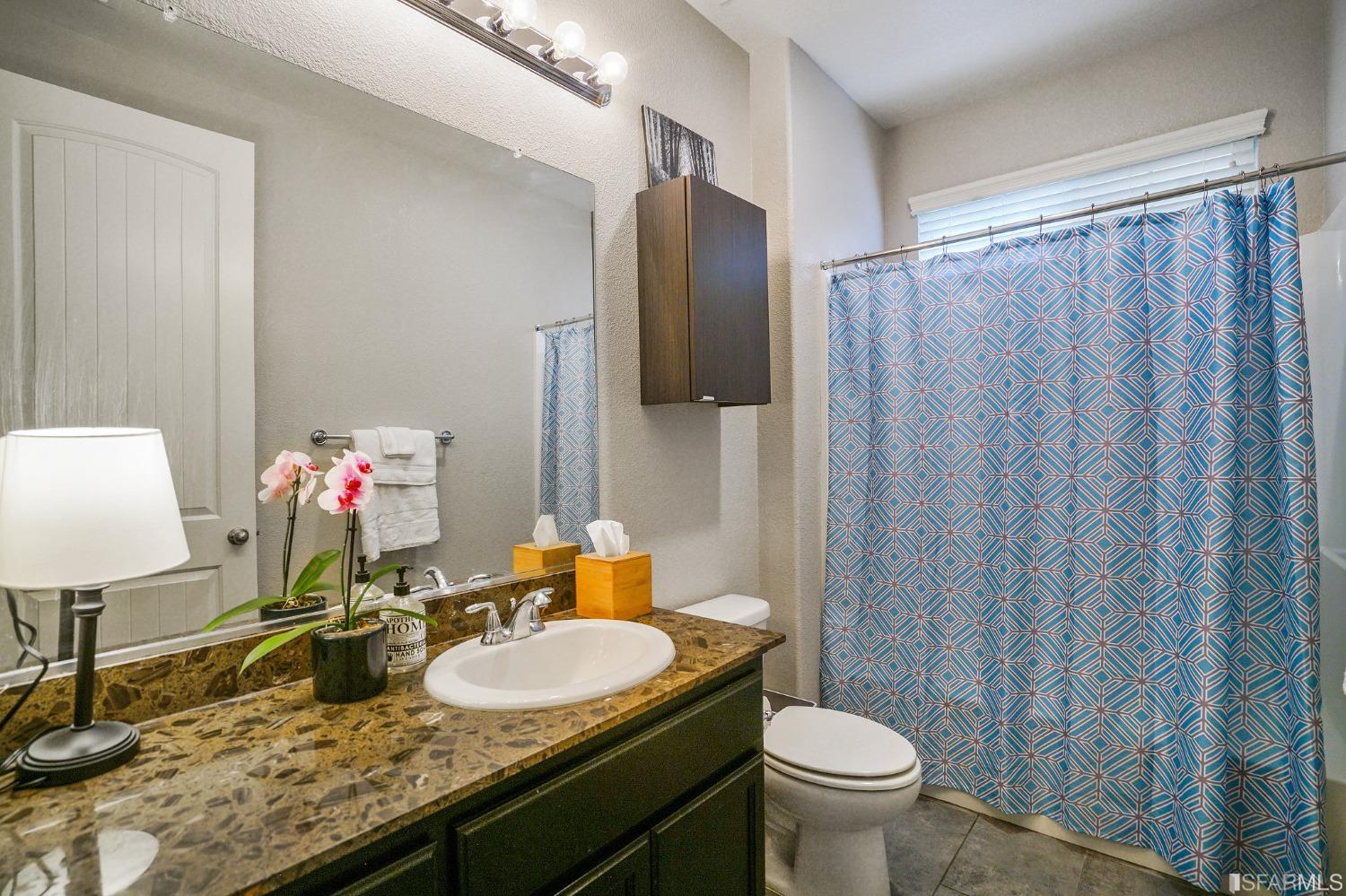 190 Belle Harbor Circle Pittsburg, CA 94565 - Photo 17 of 37 a bathroom with a granite countertop sink a toilet and a mirror