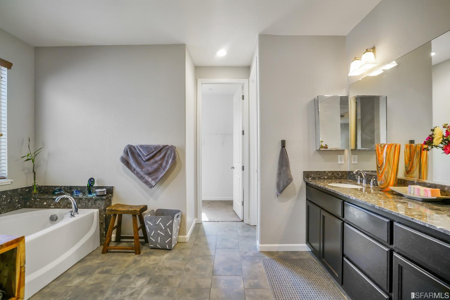 190 Belle Harbor Circle Pittsburg, CA 94565 - Photo 22 of 37 a spacious bathroom with a granite countertop sink and a bathtub