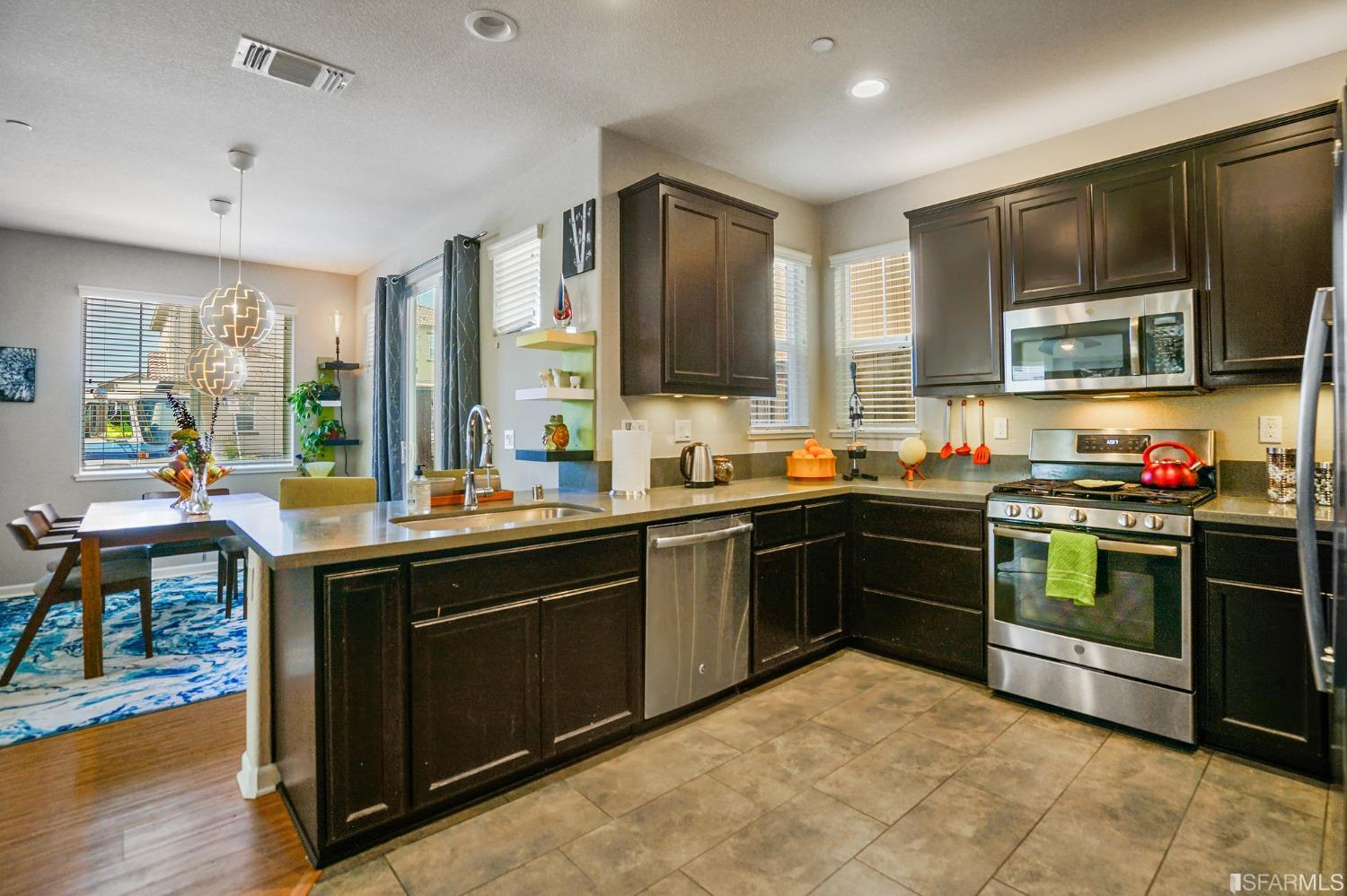 190 Belle Harbor Circle Pittsburg, CA 94565 - Photo 9 of 37 a kitchen with stainless steel appliances granite countertop a stove top oven sink and cabinets