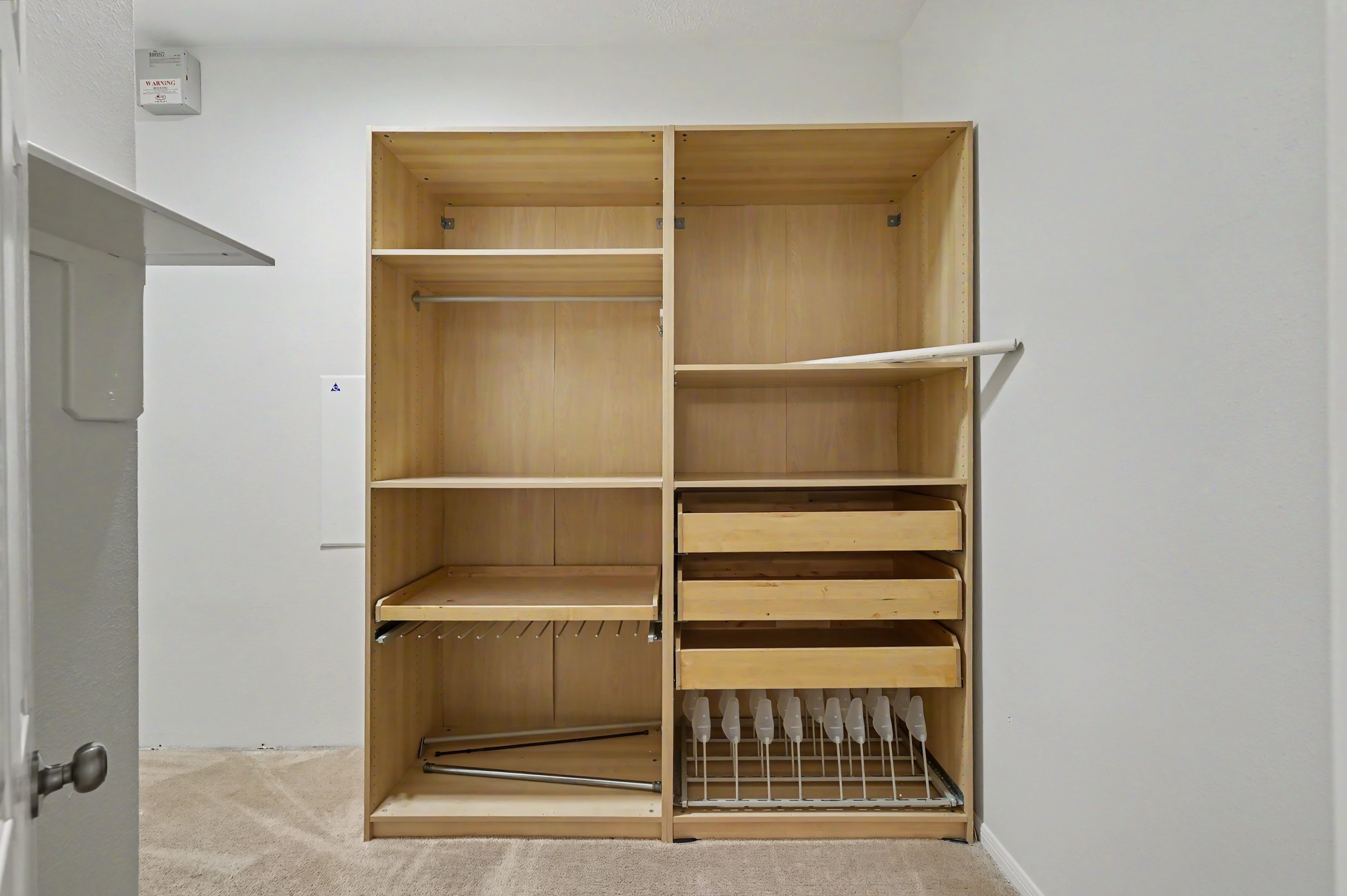 14 South Rambling Ridge Place The Woodlands, TX 77385 - Photo 22 of 42 Generous walk-in closet features a custom organization system with built-in shelving, drawers, hanging space, and shoe storage to keep everything neatly arranged.