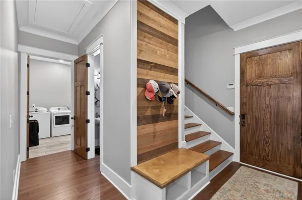 a view of a bedroom with wooden floor and flat screen tv
