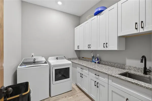 a bathroom with double vanity and a mirror