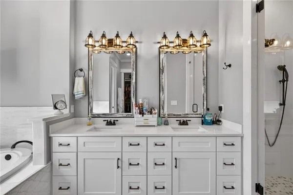 a bathroom with a granite countertop sink mirror vanity and toilet