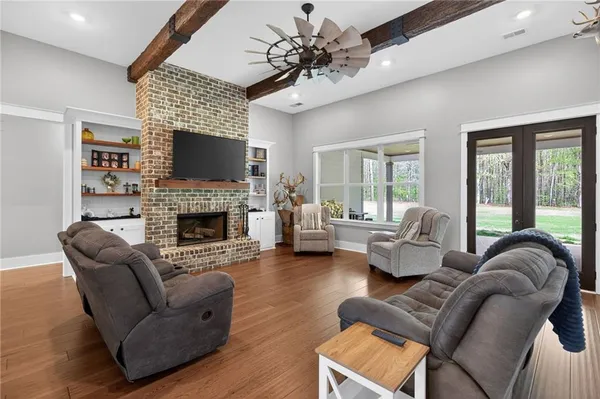 a living room with furniture and a chandelier