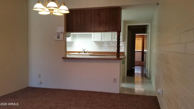 an empty room with a fireplace and window