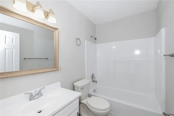 a bathroom with a sink mirror toilet and bathtub
