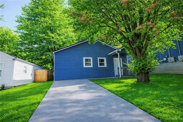 a yellow and red house with a garden