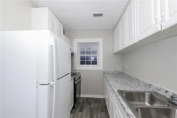 a kitchen with a refrigerator and a sink