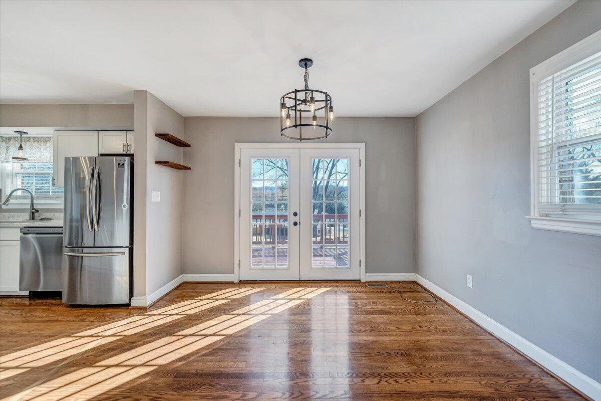 3584 Cedar Lane Roanoke, VA 24018 - Photo 12 of 75 a view of a kitchen with a stove wooden floor and a window