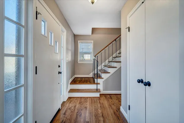 a view of entryway and hall with wooden floor