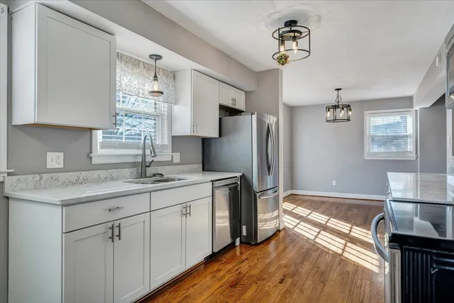 a view of a hallway with white walls and stairs