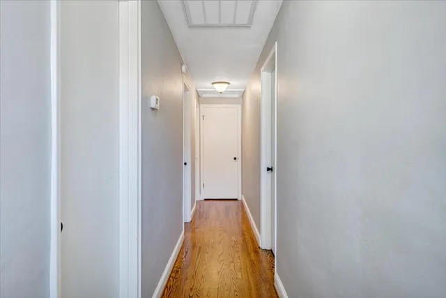 a view of room with window and wooden floor