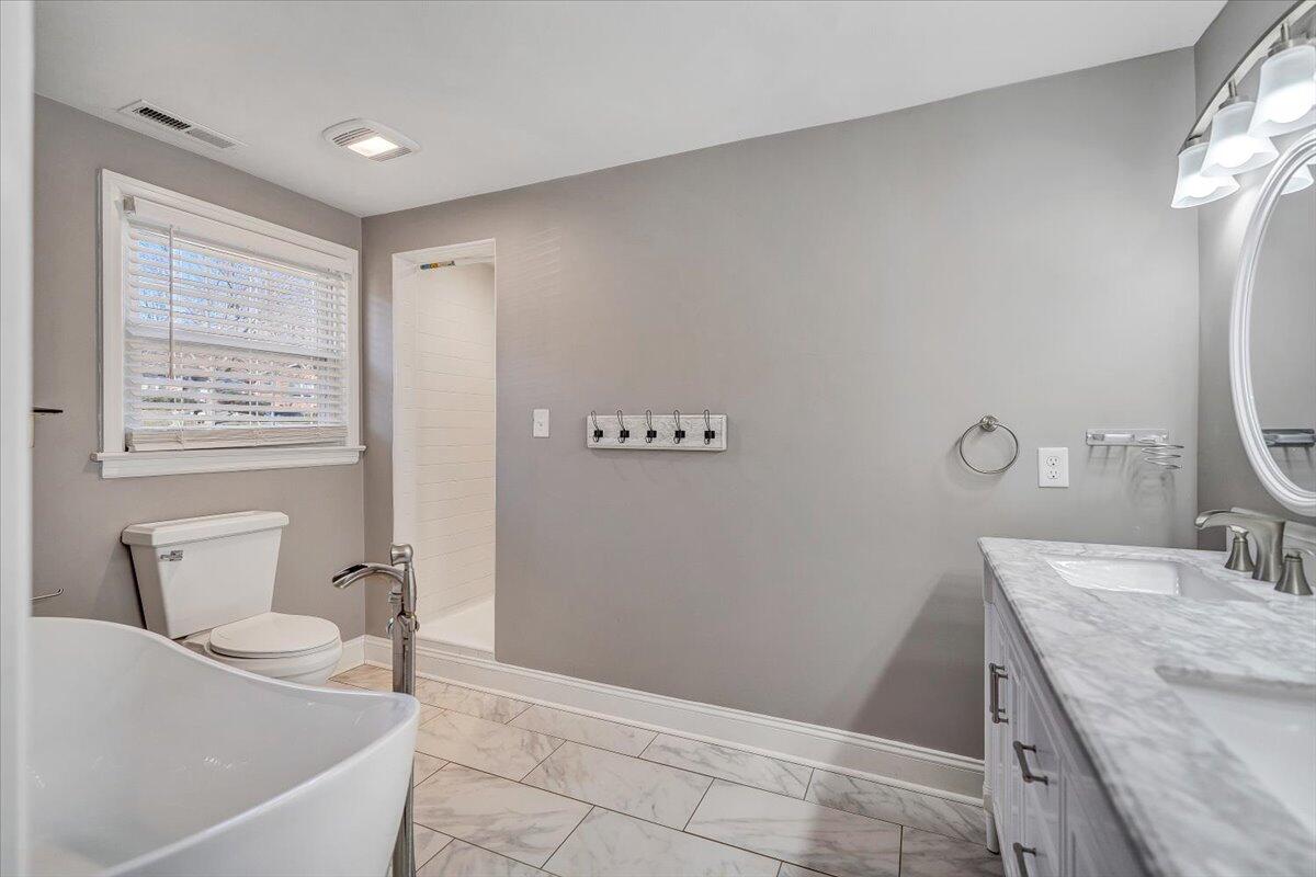 3584 Cedar Lane Roanoke, VA 24018 - Photo 34 of 75 a bathroom with a granite countertop sink a toilet and mirror