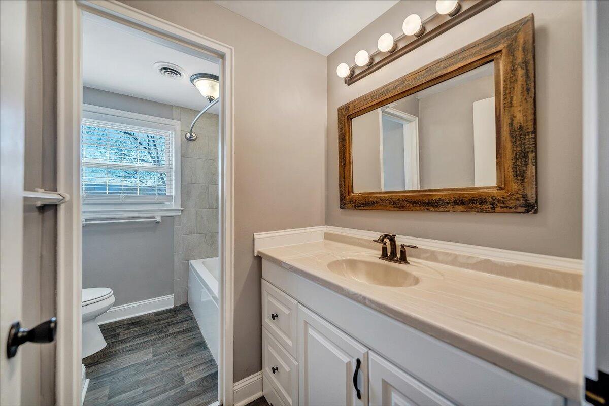 3584 Cedar Lane Roanoke, VA 24018 - Photo 43 of 75 a bathroom with a toilet a sink a vanity and mirror