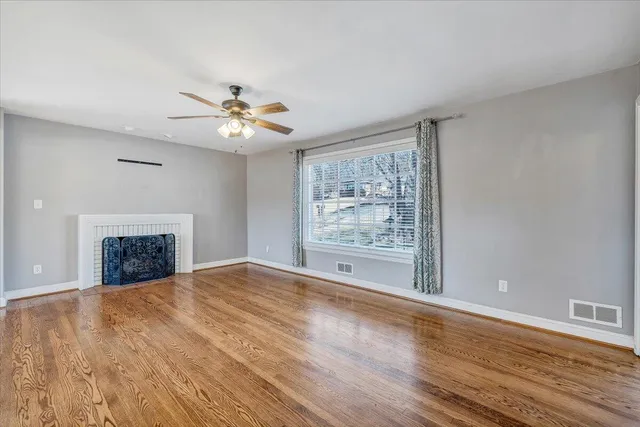 wooden floor in an empty room with a window