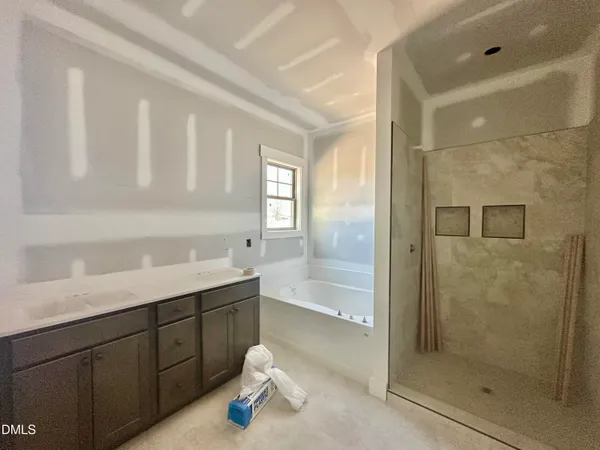 a bathroom with a shower sink and mirror