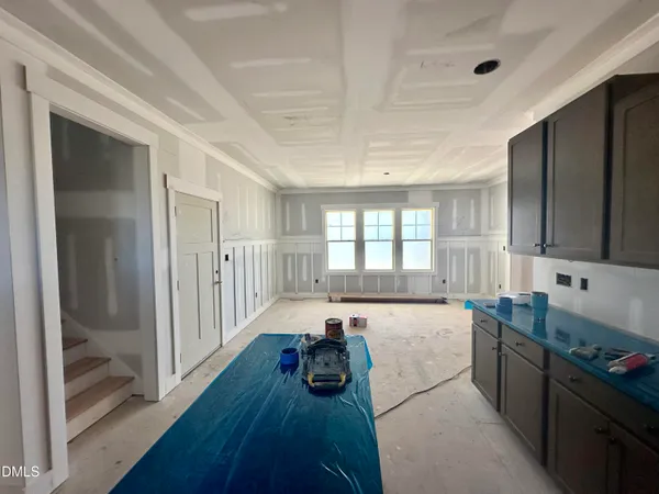 a large white kitchen with a large window