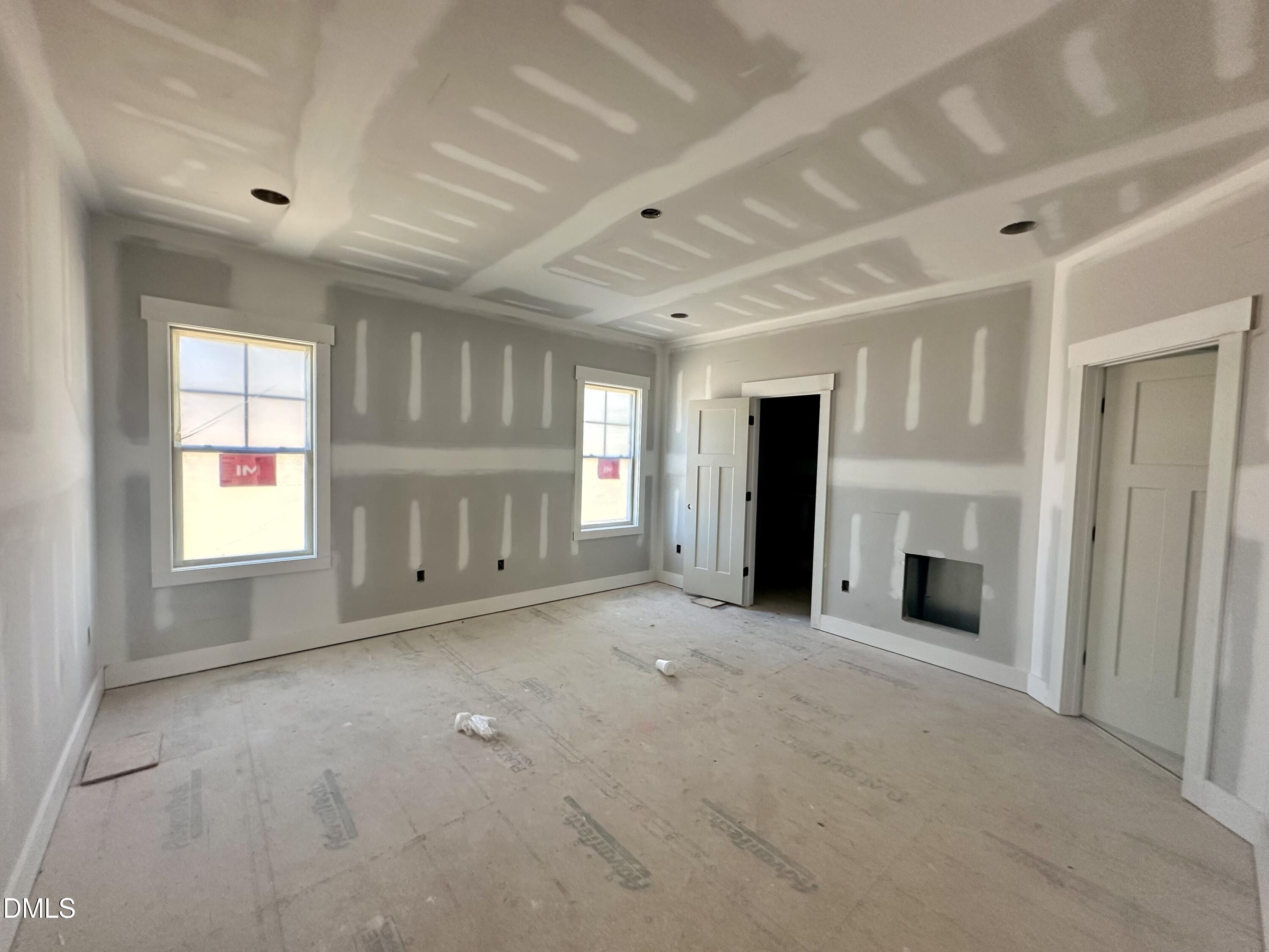 1179 Beulahtown Road Kenly, NC 27542 - Photo 9 of 26 an empty room with windows and fireplace