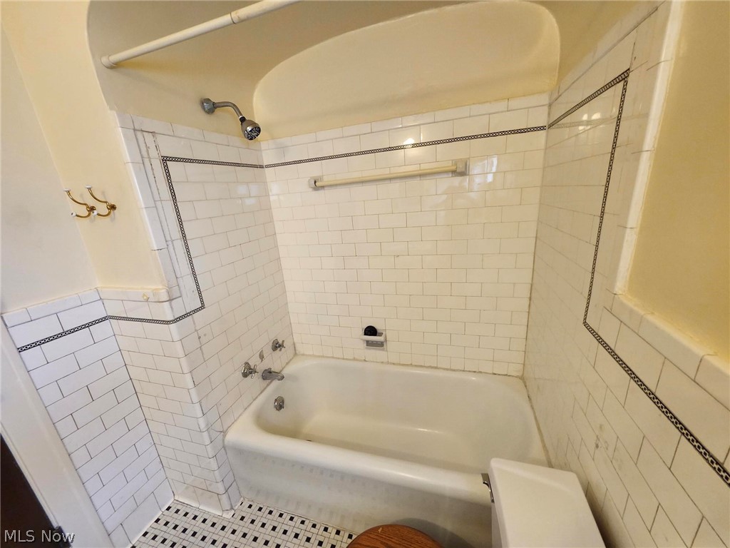3819 Woodridge Road Cleveland Heights, OH 44121 - Photo 19 of 42 Bathroom with tiled shower / bath, tile walls, and toilet