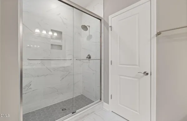 a bathroom with a double vanity sink a mirror and shower