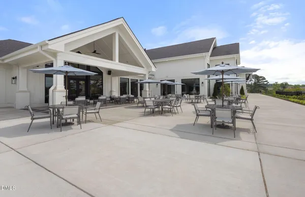 a view of a patio with dining table and chairs