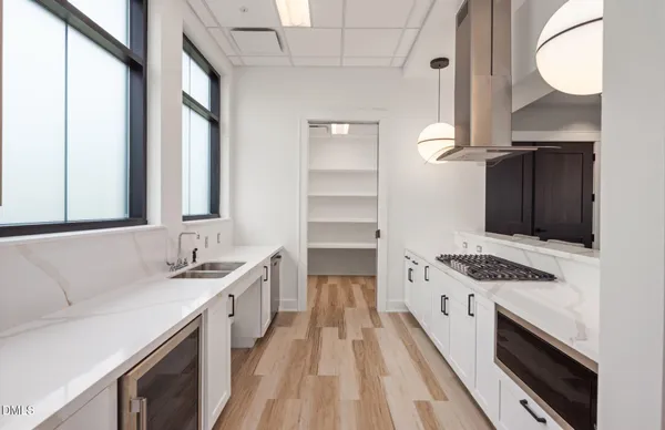 a kitchen with granite countertop a sink stove and cabinets