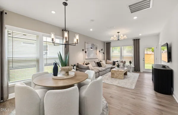 a living room with furniture and kitchen view