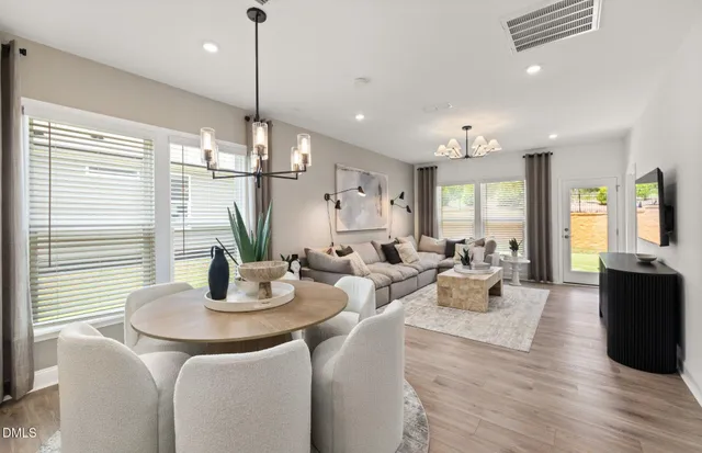 a living room with furniture and kitchen view
