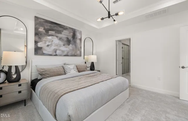 a spacious bedroom with a large bed and a chandelier