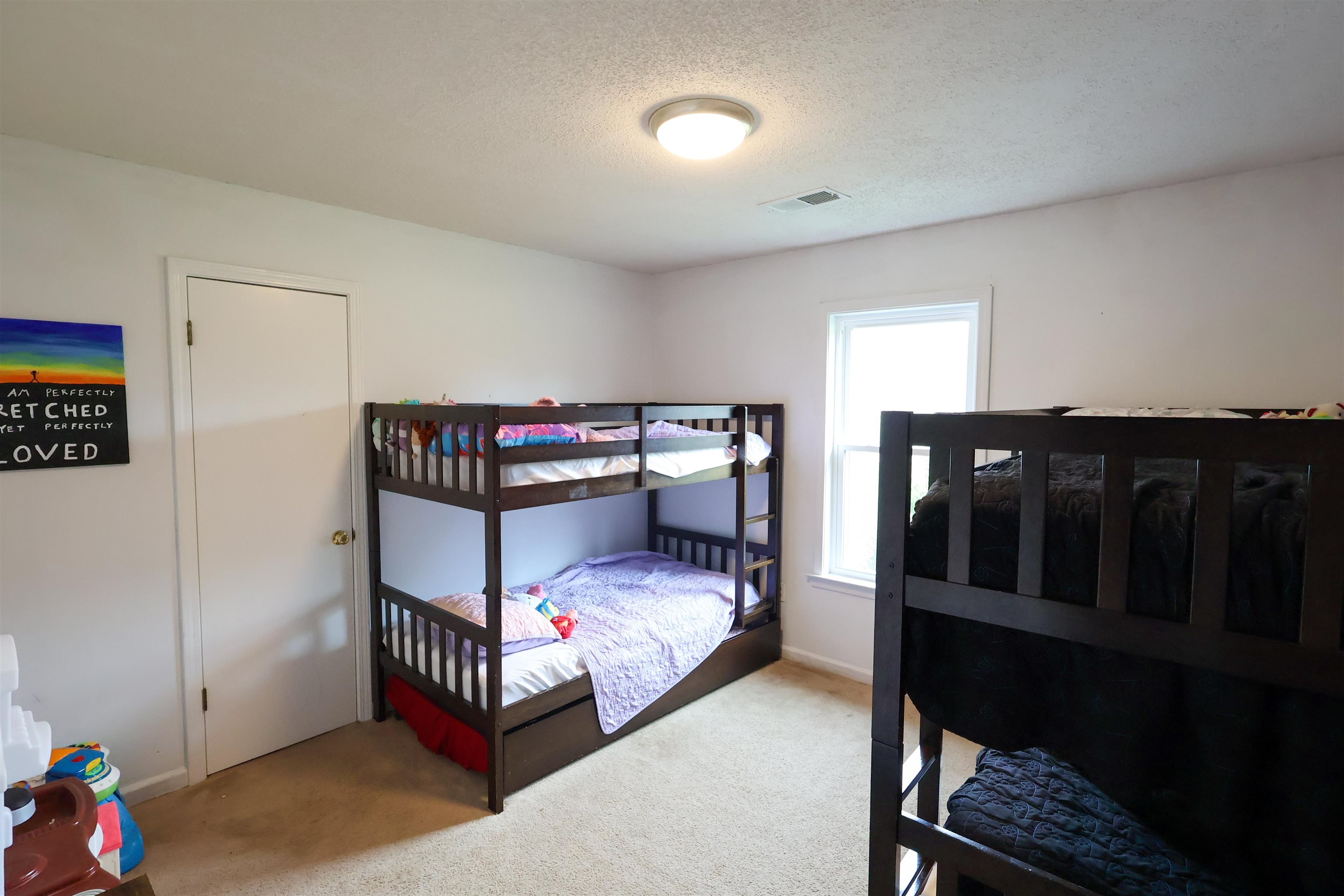 157 Nancye Reeder Avenue Munford, TN 38058 - Photo 11 of 17 a bedroom with bed and wooden floor