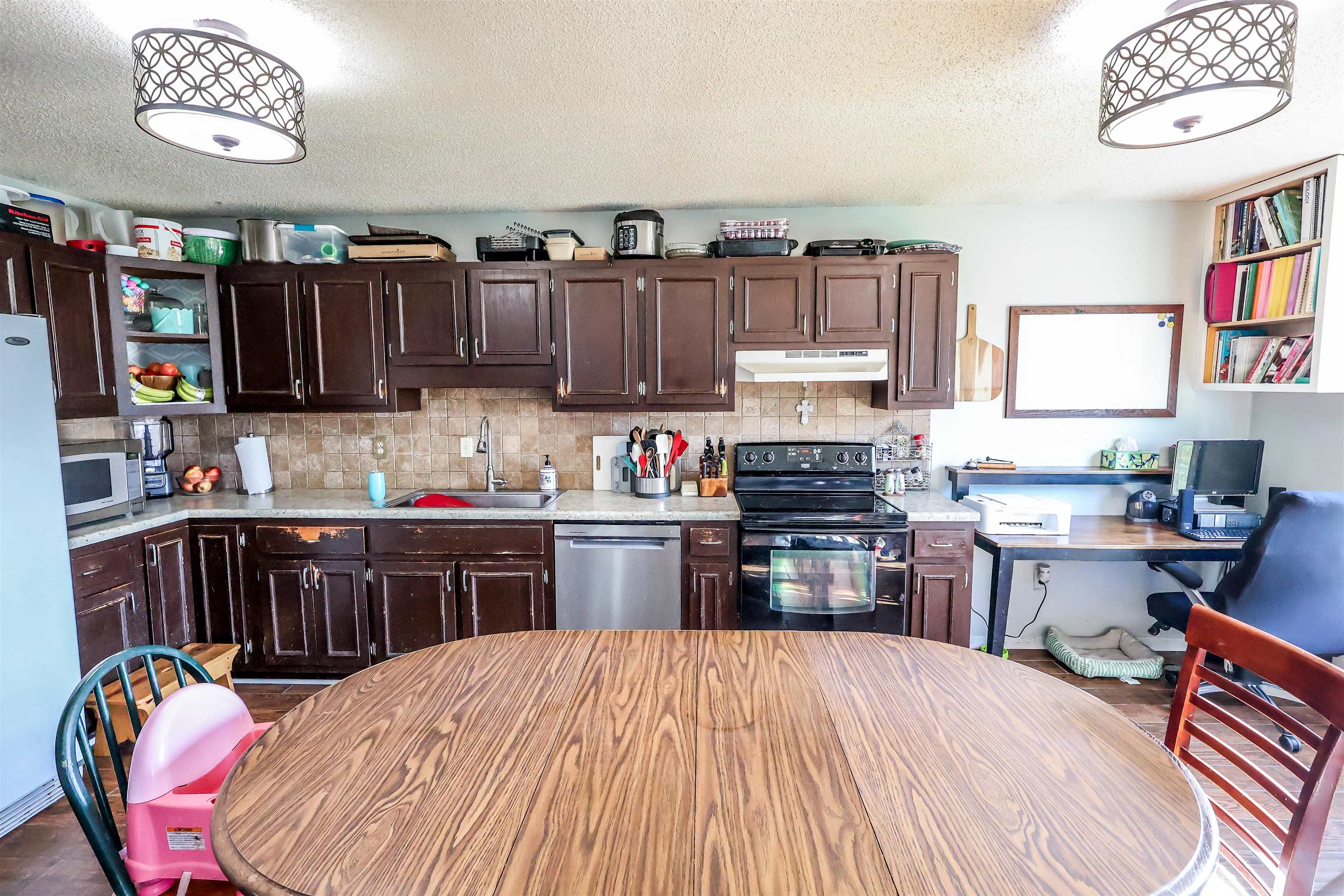 157 Nancye Reeder Avenue Munford, TN 38058 - Photo 9 of 17 a kitchen with stainless steel appliances granite countertop a refrigerator stove top oven and sink