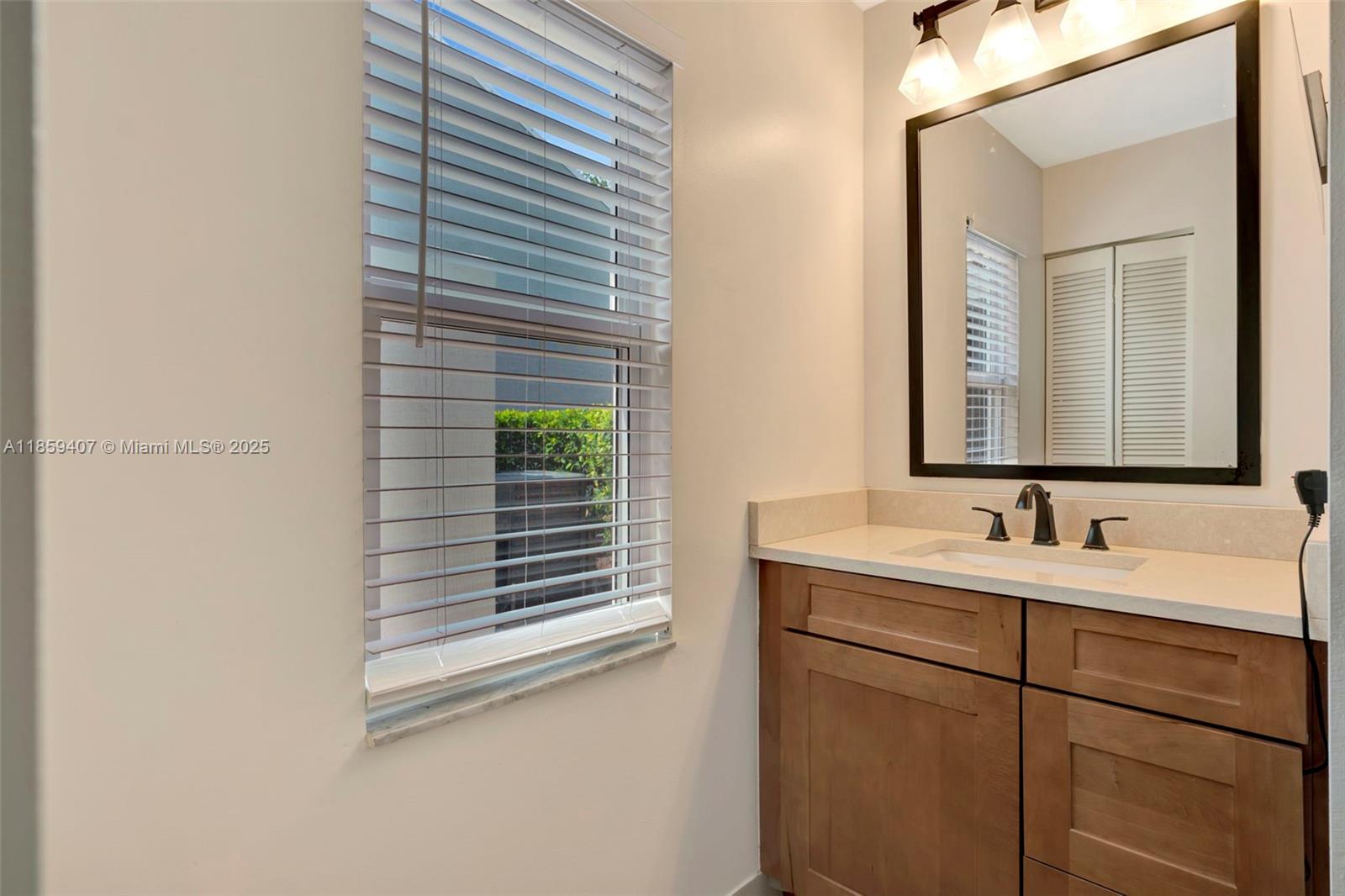 17068 Traverse Circle Jupiter, FL 33477 - Photo 36 of 72 a bathroom with a sink and a mirror