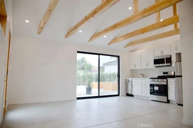 a view of a kitchen with a sink and a stove top oven
