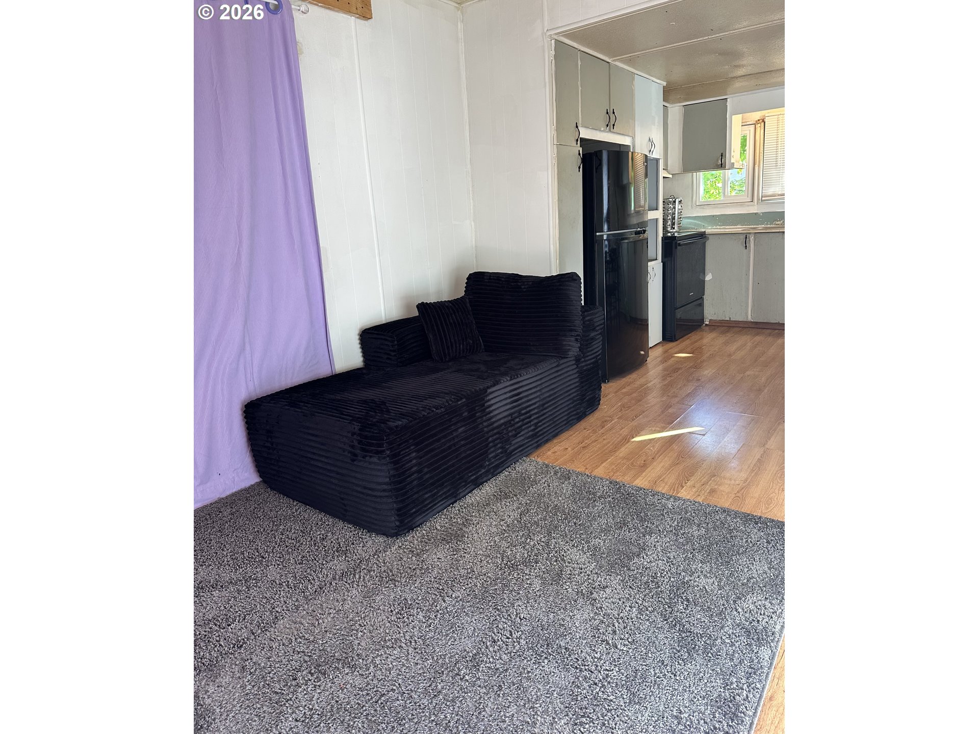 37635 Row River Road, Unit 7 Dorena, OR 97434 - Photo 11 of 27 a living room with furniture and a refrigerator