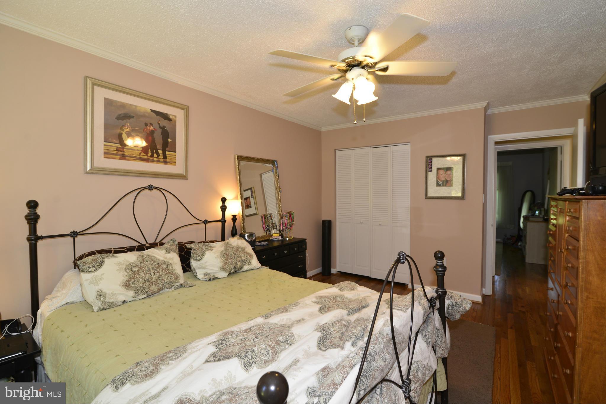2065 Golf Course Drive Reston, VA 20191 - Photo 15 of 30 a bedroom with a bed and a chandelier