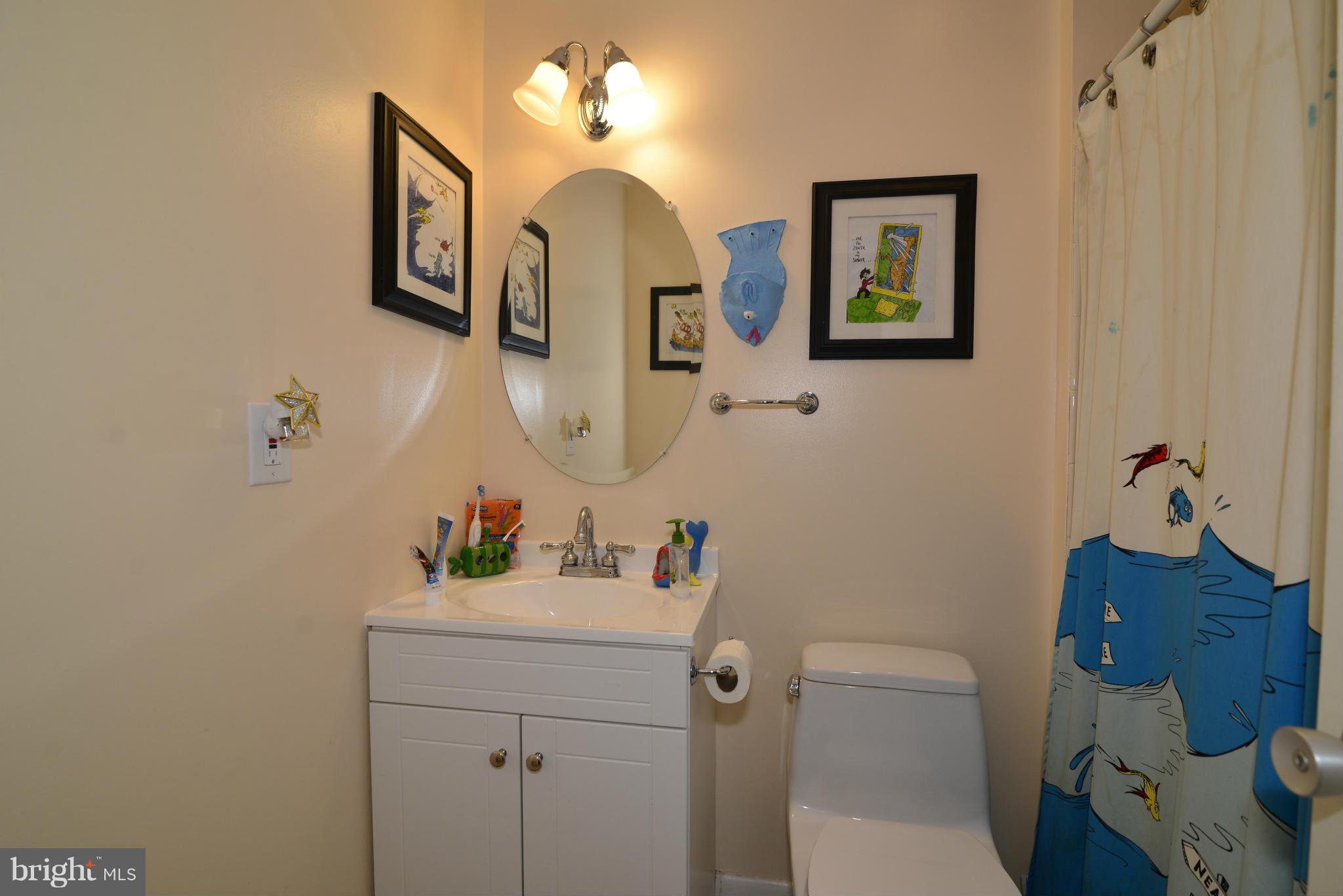 2065 Golf Course Drive Reston, VA 20191 - Photo 29 of 30 a bathroom with a sink vanity mirror and toilet