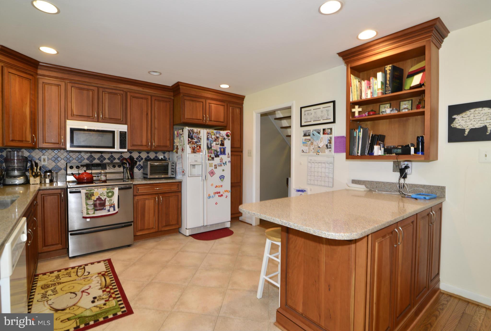 2065 Golf Course Drive Reston, VA 20191 - Photo 7 of 30 a kitchen with stainless steel appliances granite countertop a refrigerator sink and stove