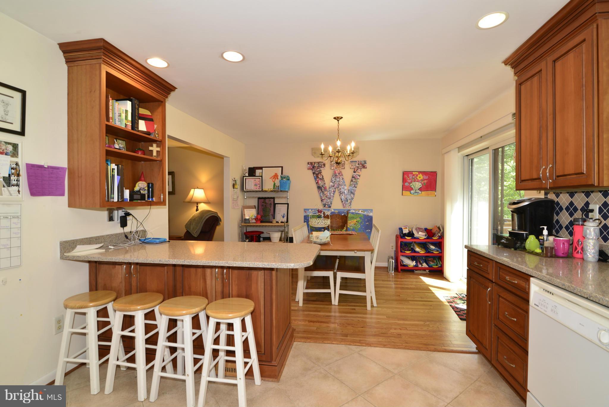 2065 Golf Course Drive Reston, VA 20191 - Photo 9 of 30 a room with stainless steel appliances a dining table chairs and a refrigerator