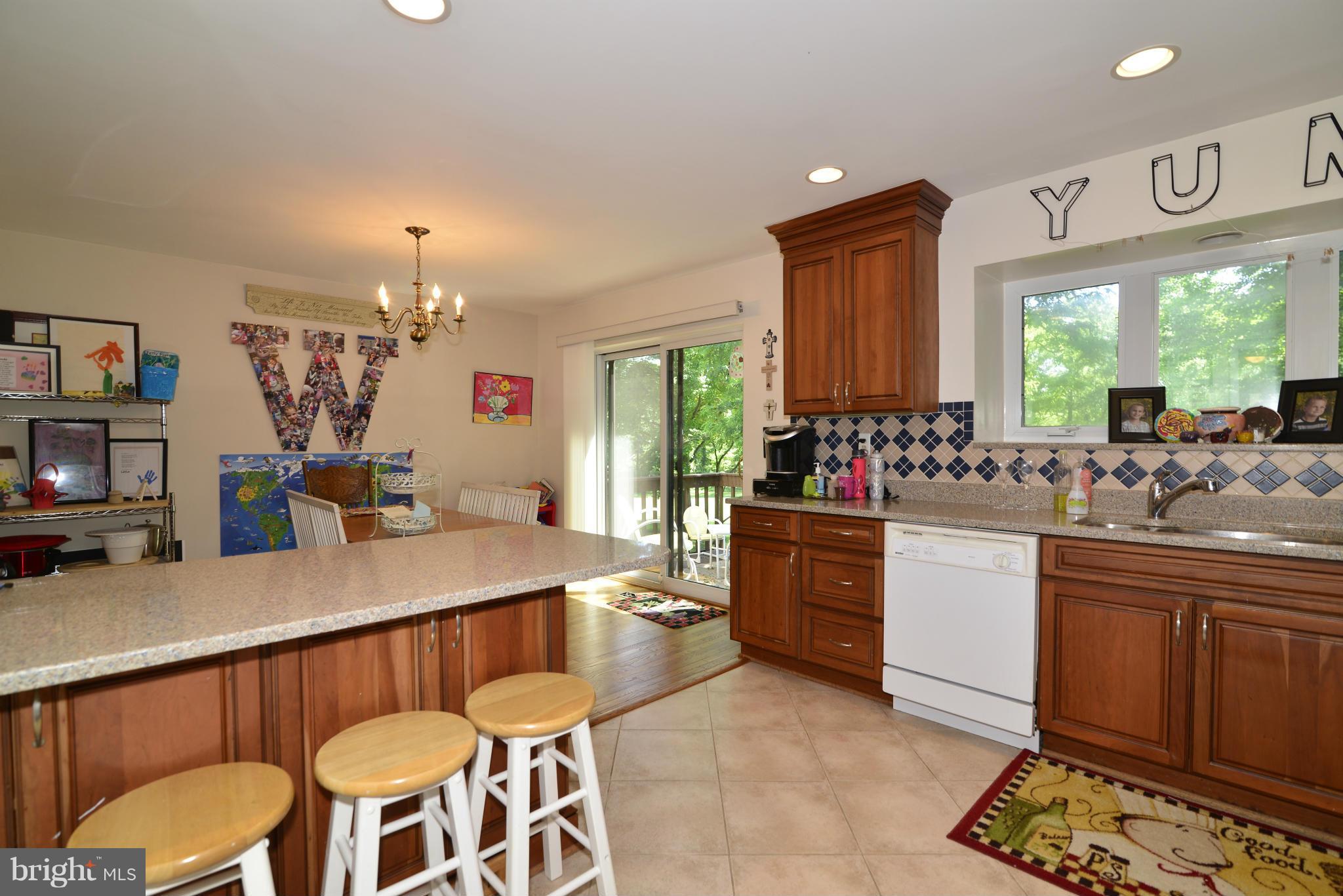 2065 Golf Course Drive Reston, VA 20191 - Photo 10 of 30 a kitchen with stainless steel appliances kitchen island granite countertop a sink and cabinets