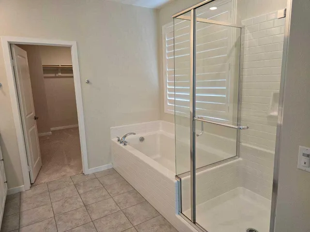 a bathroom with a bathtub and shower