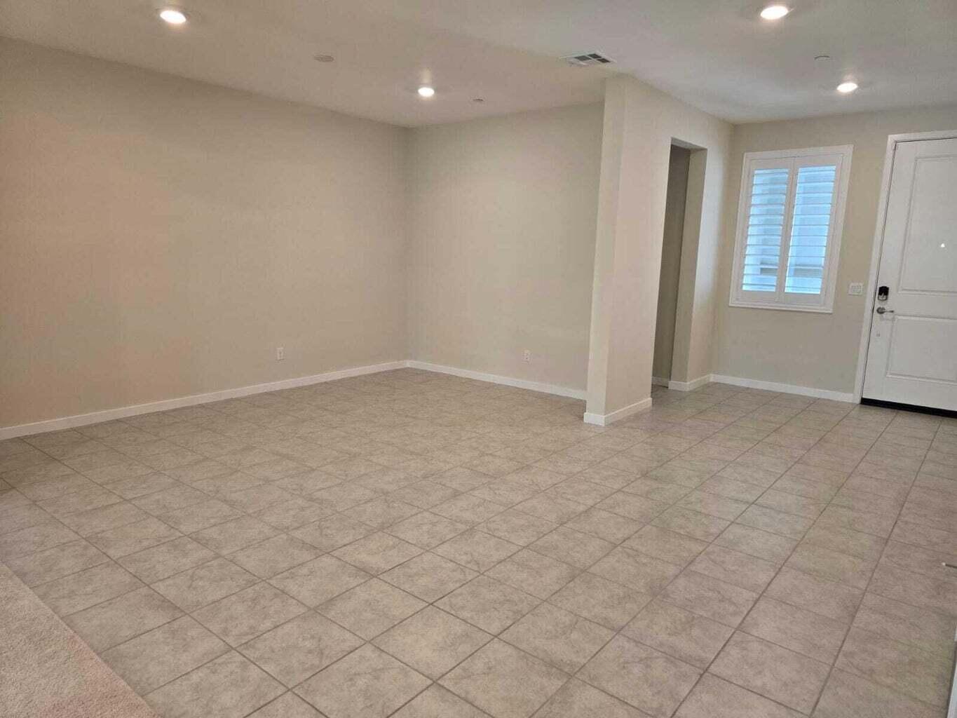 82117 Verdi Road Indio, CA 92203 - Photo 4 of 24 an empty room with white cabinet and windows