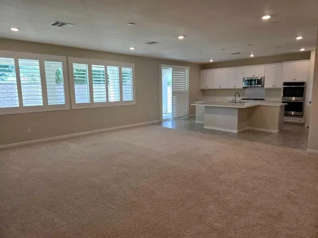 a big room with kitchen view and hall
