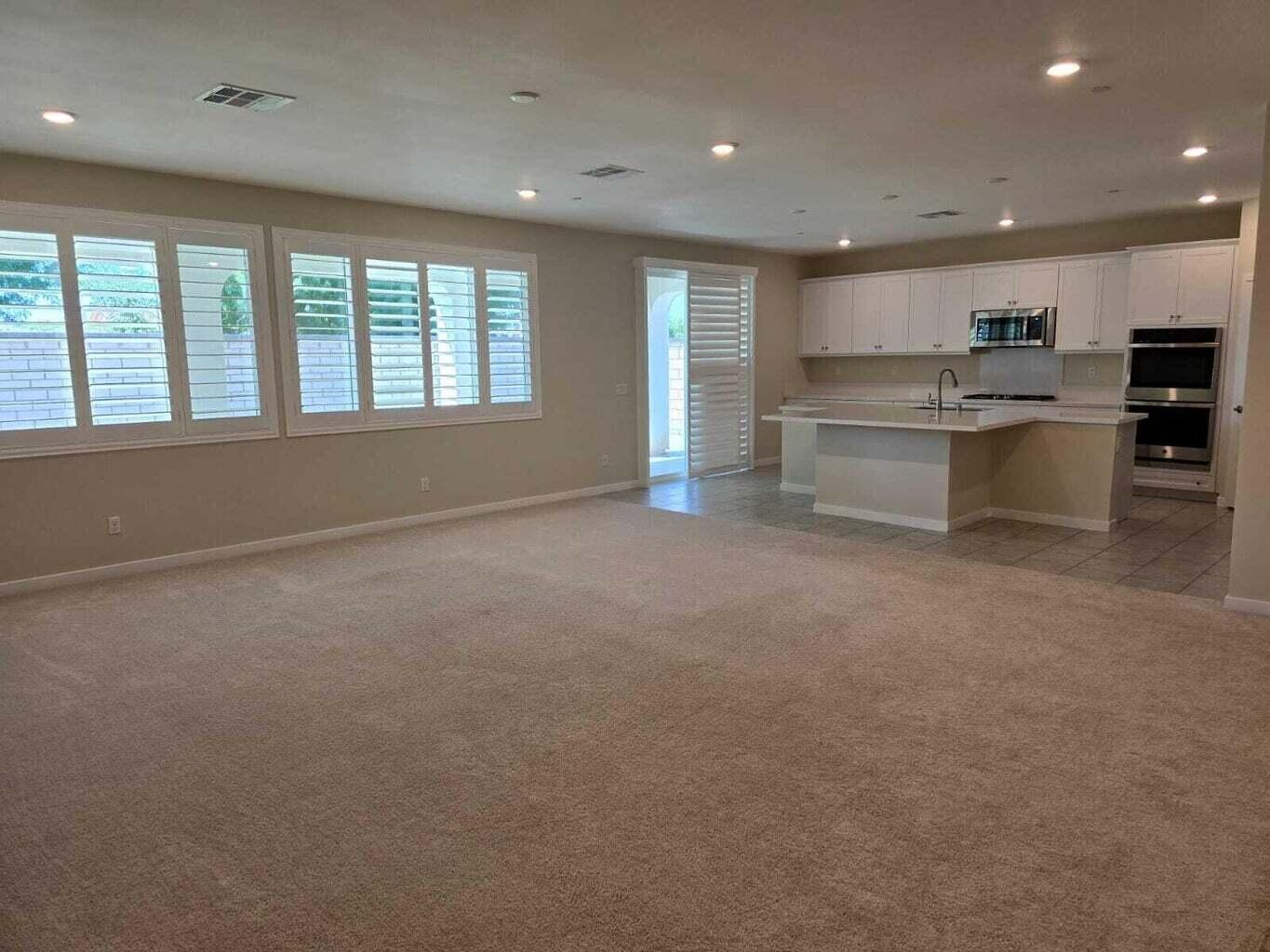 82117 Verdi Road Indio, CA 92203 - Photo 5 of 24 a big room with kitchen view and hall