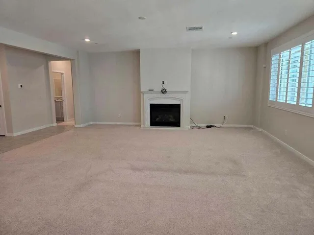 a view of empty room with a fireplace
