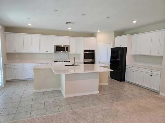 a kitchen with cabinets and stainless steel appliances