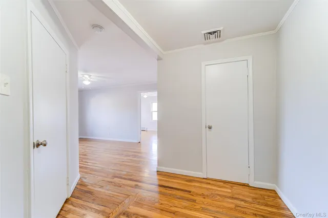a view of hallway with wooden floor