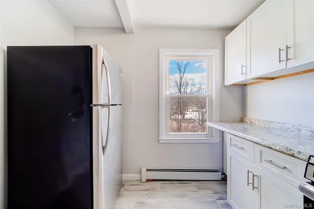 a kitchen with appliances cabinets and a window