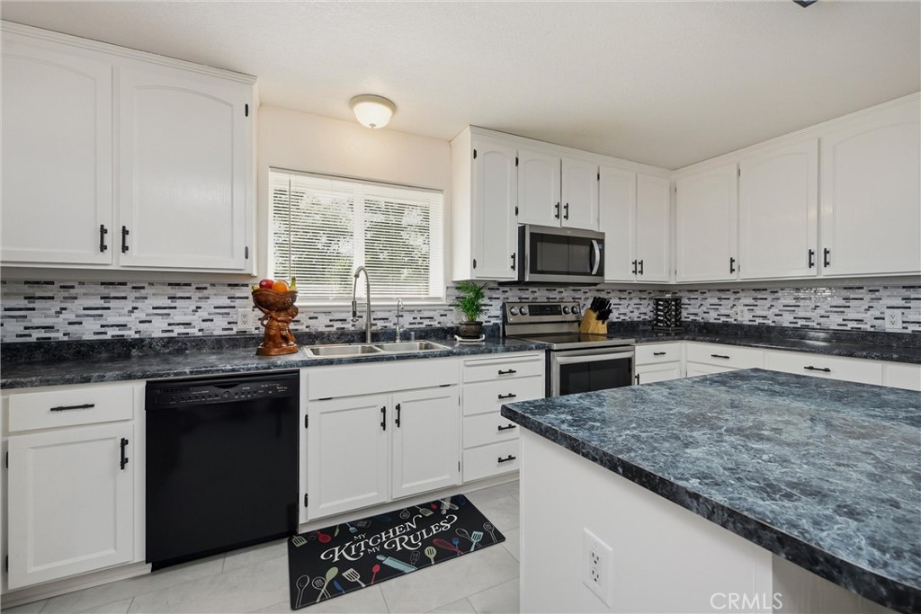 18685 Oak Grove Road Hidden Valley Lake, CA 95467 - Photo 2 of 52 a kitchen with granite countertop a sink stove and cabinets