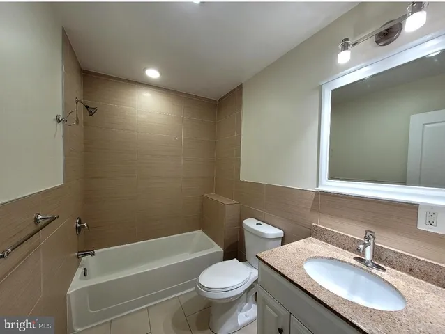 an empty room with wooden floor and window